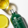 Gentle Green Oil Pulling pouring from glass bottle – smooth, plant-based mouth detox oil with nano-hydroxyapatite
