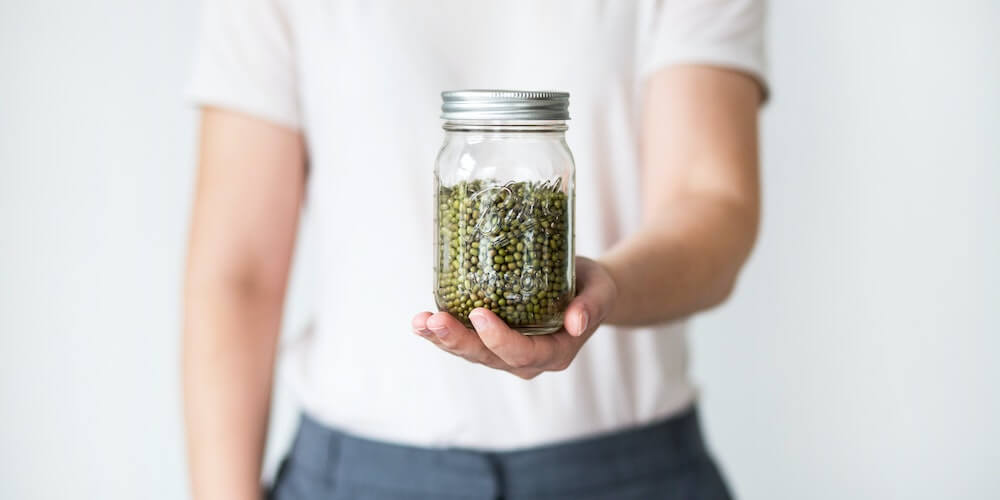 A reusable glass jar filled with grains