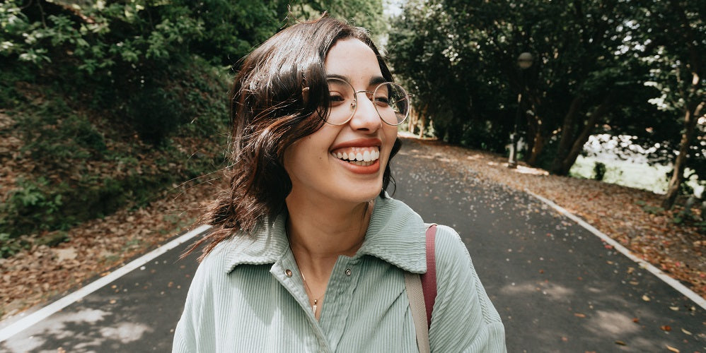 woman smiling walking down the street 