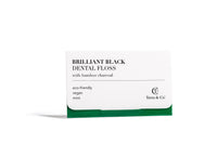 Single strand of Terra & Co.'s charcoal dental floss showing smooth black fiber with candelilla wax coating for easy glide