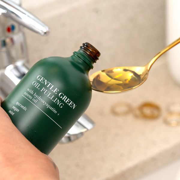 1 teaspoon of Gentle Green Oil Pulling Mouthwash – rich botanical blend for detox and enamel support