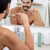 Man brushing his teeth with Terra & Co. Gentle Green® hydroxyapatite toothpaste as part of a clean morning routine