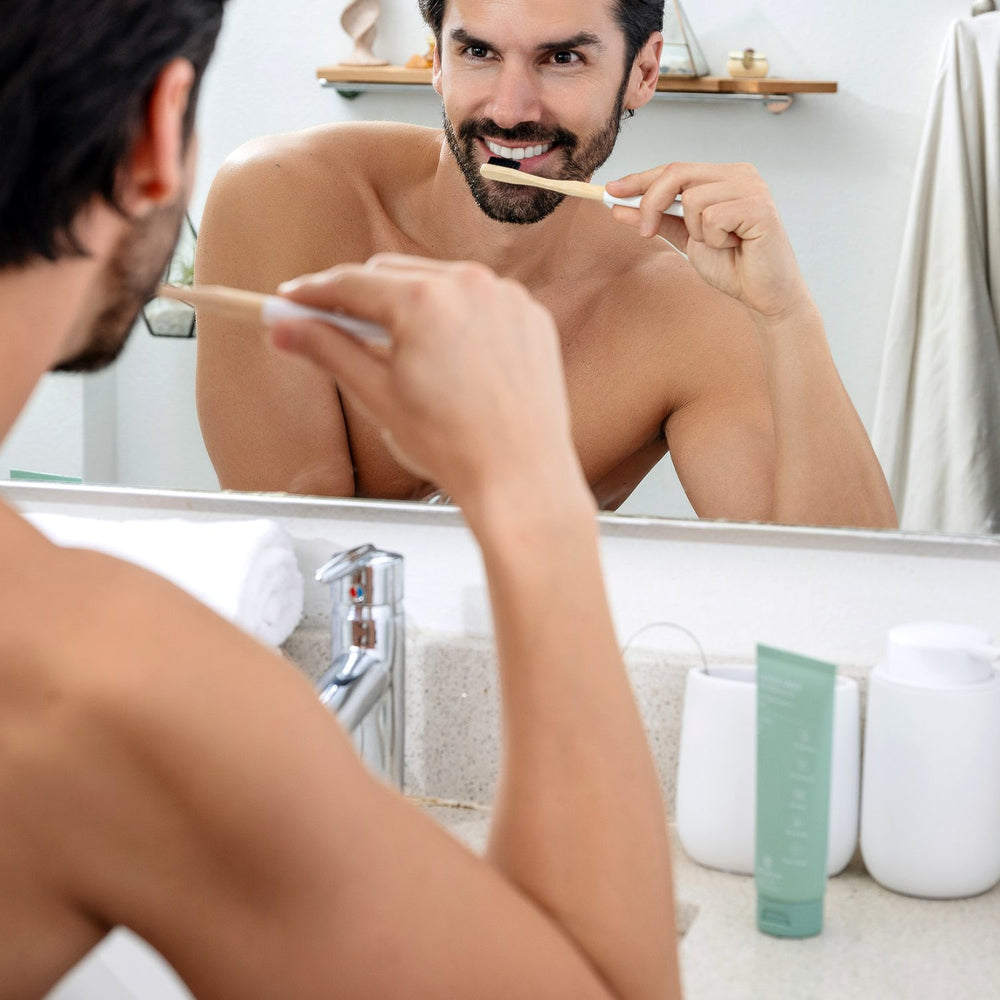 Man brushing his teeth with Terra & Co. Gentle Green® hydroxyapatite toothpaste as part of a clean morning routine