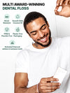 Multi award-winning Brilliant Black® charcoal bamboo dental floss – smiling man holding black floss and box: shred-resistant, smooth glide with coconut oil, PFAS & fluoride-free, plastic-free packaging, activated charcoal whitens between teeth