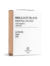 Terra & Co. Brilliant Black® Dental Floss in recyclable packaging, made with activated charcoal and bamboo fiber for natural whitenin